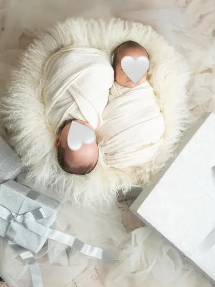 Twice the love, twice the joy. This is a beautifully simple setup for newborn twins, swaddled together in a soft, cloud-like nest.