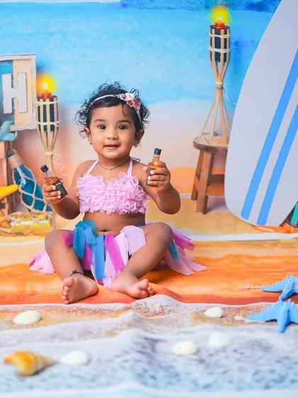 Let's go to the beach. This vibrant, sunny setup is perfect for celebrating your little one's bright personality. I provide all the props to create a fun, beachy vibe right in my studio.