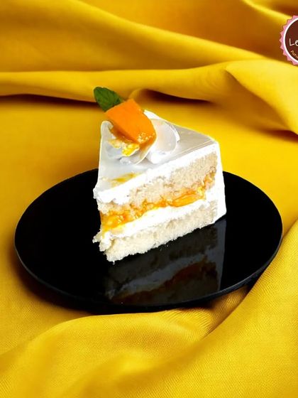 A slice of my Fresh Mango Pastry. This dessert features layers of soft vanilla sponge, light whipped cream, and sweet mango pieces, creating a classic and refreshing fruit pastry.