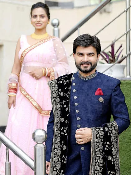 A classic portrait with the groom in focus. This shot highlights his sharp attire while keeping his beautiful partner in the frame.