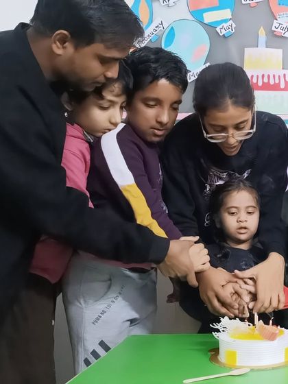 Everyone wants to be a part of the big moment. Helping to hold the knife to cut the cake makes every child feel included in the celebration.