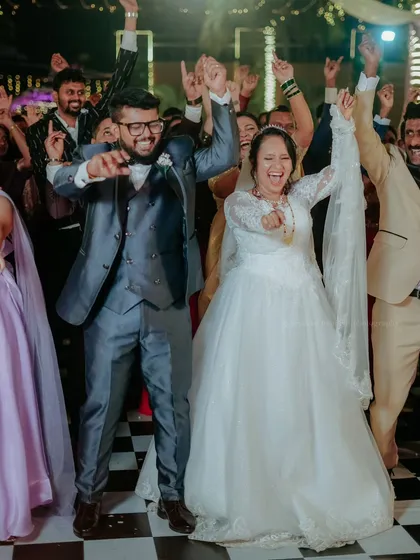 The couple and their friends celebrate on the dance floor, a perfect picture of joy and friendship.
