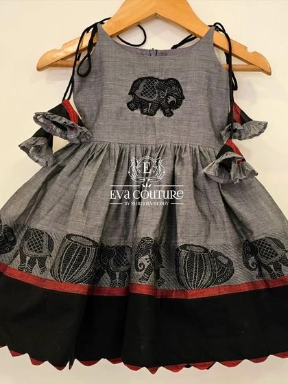 A modern and stylish frock made from grey handloom cotton. It features cold-shoulder sleeves and a block print of elephants.