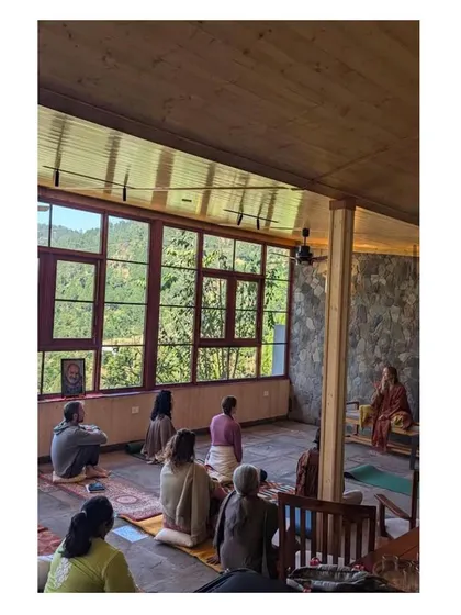 The meditation pavilion at the Uttarakhand homestay in use. We designed this space with a delicate butterfly roof to be a place of stillness and reflection, where the architecture itself encourages a connection to the serene mountain surroundings.
