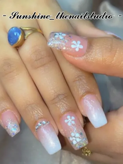 A pretty set with a white ombre, glitter, and hand-painted flowers.