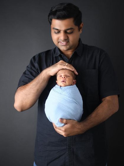 A father holding his newborn son for the first time is a memory to cherish forever. I always encourage parents to be part of the session to capture these powerful, emotional connections.