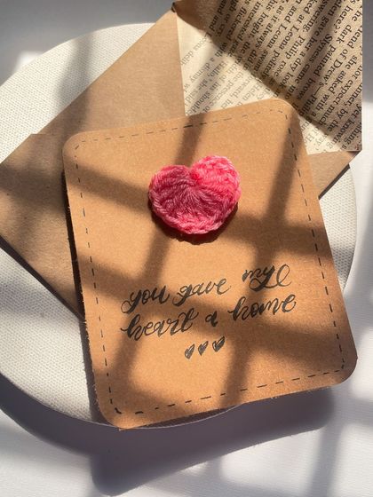 Another angle of the crochet heart card, showing the texture of the paper and the handmade envelope it comes with.