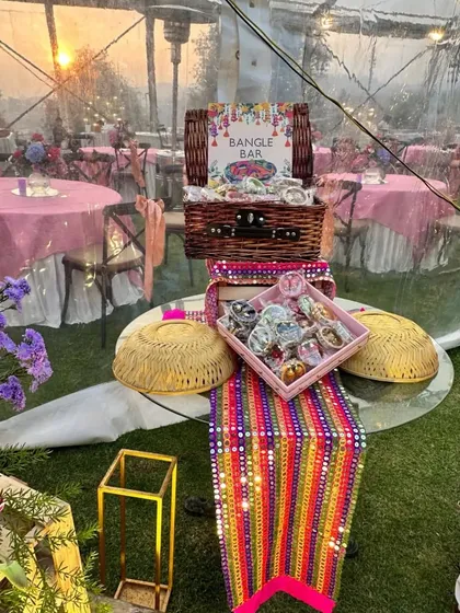 We create engaging experiences like this 'Bangle Bar' for a Mehendi ceremony. This interactive wedding favor station allows guests to choose their own colorful bangles, creating a memorable and personalized takeaway from your event.