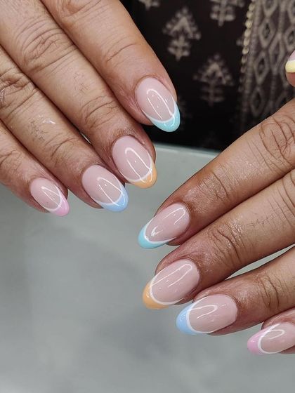Another view of the popular pastel rainbow French tips. This design works beautifully on natural, well-shaped nails for a clean and modern look.