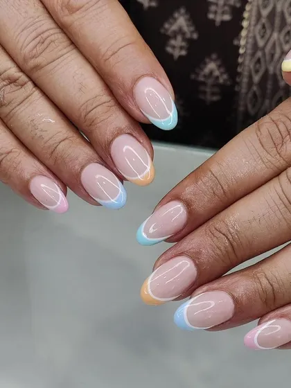 Another view of the popular pastel rainbow French tips. This design works beautifully on natural, well-shaped nails for a clean and modern look.