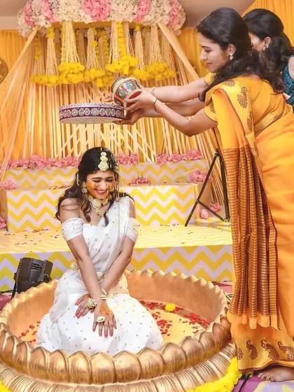 Another joyful moment from the Haldi ceremony, with guests showering the bride with flower petals.