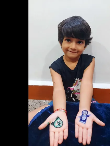 A happy little client showing off her custom cartoon mehendi. Seeing her smile is the best reward.