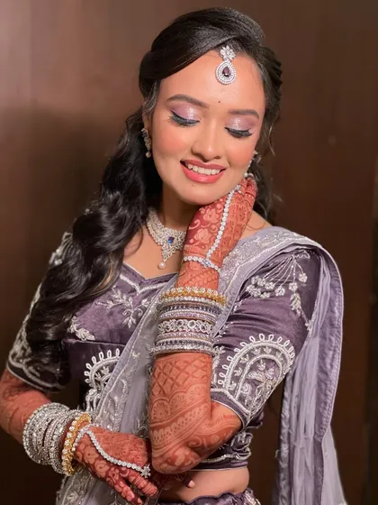 A close-up showing the intricate details of her henna and the beautiful diamond bracelets.
