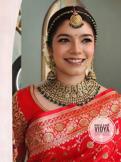 Our beautiful bride Mefania. My artist Vidya created this stunning look with a classic red Banarasi saree, a clean bun, and timeless gold jewellery.