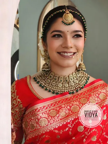 Our beautiful bride Mefania. My artist Vidya created this stunning look with a classic red Banarasi saree, a clean bun, and timeless gold jewellery.