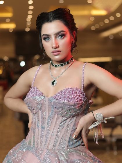 A close-up of the bodice of the metallic gown, showing the pearl and crystal embellishments on the bustier.