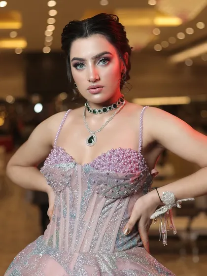 A close-up of the bodice of the metallic gown, showing the pearl and crystal embellishments on the bustier.