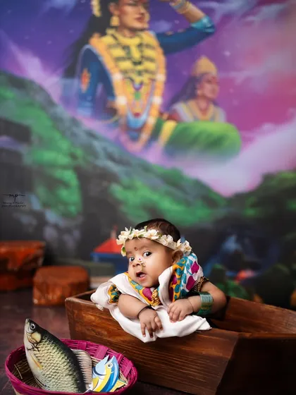 A sweet baby girl dressed in a traditional Koli outfit for her milestone session. The vibrant colors and unique theme make for unforgettable photos.