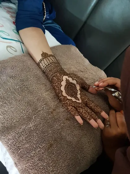 A behind-the-scenes shot of me working on an intricate Pakistani-style henna design.
