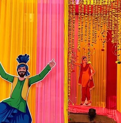 Fun and quirky decor elements for a Lohri party. These cutouts of Bhangra dancers add a playful and festive touch to the photo booth area.