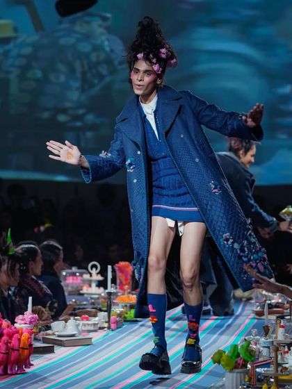 This runway look for Lakme Fashion Week involved creating a structured, gravity-defying updo with floral accents. The hairstyle was designed to be both whimsical and architectural, matching the creative spirit of the collection.