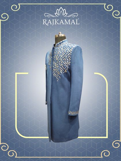 A side view of the blue jacket with geometric mirror work, showing the asymmetrical design.