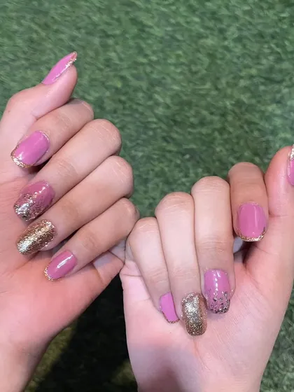 A beautiful bridal set combining soft pink polish with gold glitter accents and fine gold French tips. This design is both romantic and glamorous.