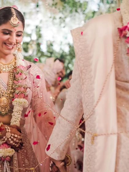 A candid shot of the couple walking hand in hand after their Varmala, their smiles reflecting the joy of the moment.