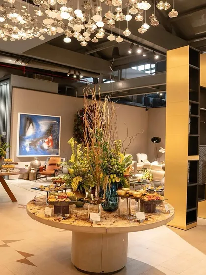 The central grazing table at the Casa Mia event, a stunning display of food and floral arrangements.