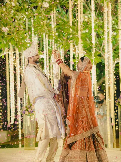 A candid and joyful varmala moment. We captured the bride playfully putting the garland on the groom amidst a shower of petals.