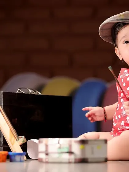 A creative "little artist" themed baby photoshoot. We have a variety of props and concepts available at our studio to make your child's session unique.