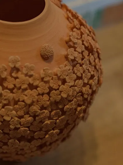 Here is the floral vase after its first firing, known as a bisque. The intricate details of the unglazed clay flowers are so beautiful on their own, it almost feels a shame to glaze it.