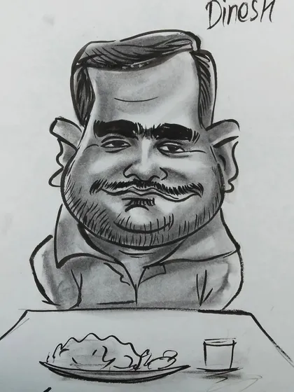 A finished caricature of a guest named Dinesh, complete with a plate of food. It’s the little details that make each drawing special.