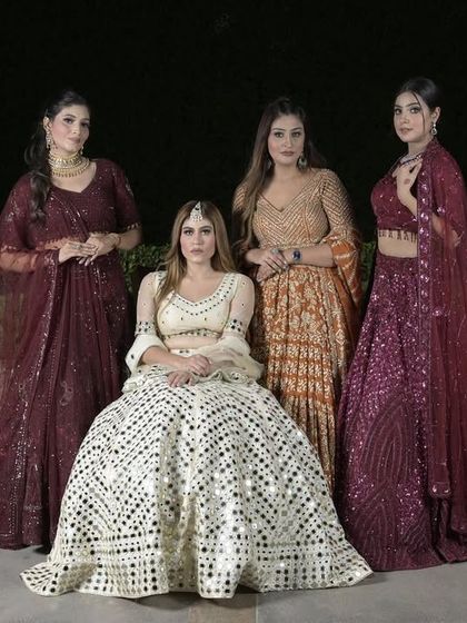 A stunning group shot featuring our embellished lehengas in shades of ivory, wine, and rust. This showcases the variety of colors and styles available for brides and bridesmaids.