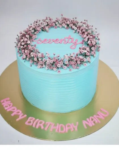 A simple and beautiful cake for a 70th birthday. This fresh pineapple buttercream cake is decorated with a wreath of delicate baby's breath flowers.
