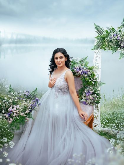 A beautiful, smiling portrait of the mom to be. The soft lighting and surrounding flowers create a gentle and joyful mood for this outdoor maternity session.