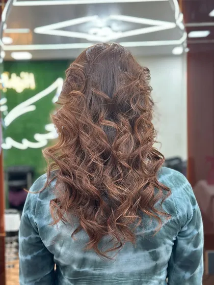Beautiful and striking. This global color is styled into bouncy curls for a glamorous finish.