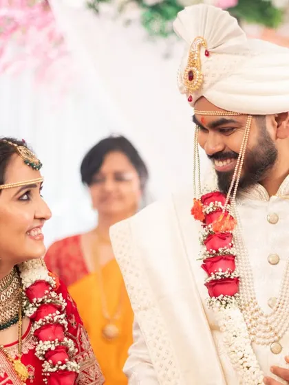 A beautiful, happy glance exchanged between the couple at their mandap.