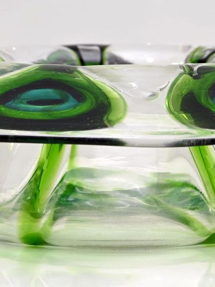 A side view of the Loetz-style glass bowl, showing the depth and dimension of the 'Peacock Feather' design within the glass. This is a fine example of early 20th-century Bohemian glasswork.