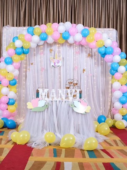 A magical 'Mermaid' themed birthday party, with shimmering blue and green decor, seashell props, and mermaid cutouts, creating an enchanting underwater world.
