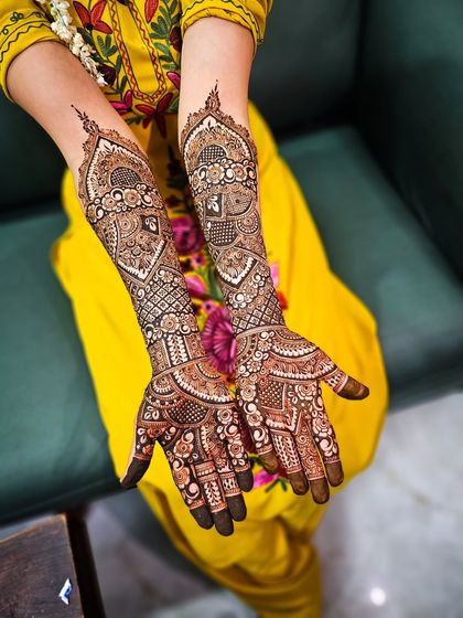 I love creating full, flowing designs that cover the hands and arms in a seamless story of patterns, from geometric grids to soft florals.