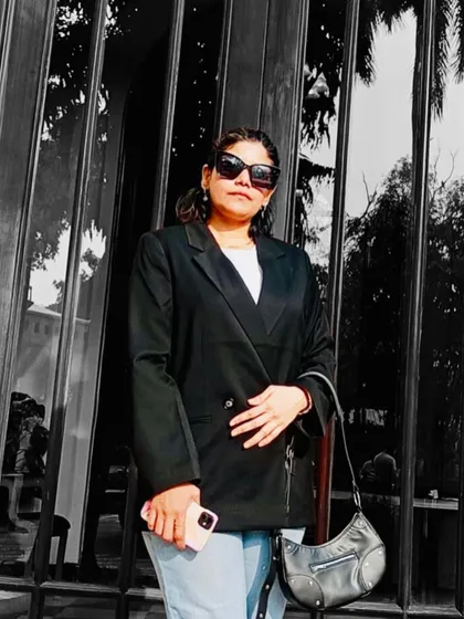 A closer, black-and-white filtered shot of the blazer outfit, focusing on the silhouette and mood.