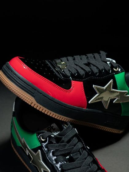 A dynamic angle of the Bapesta UAE edition, emphasizing the iconic star and thunderbolt logo in a metallic finish.