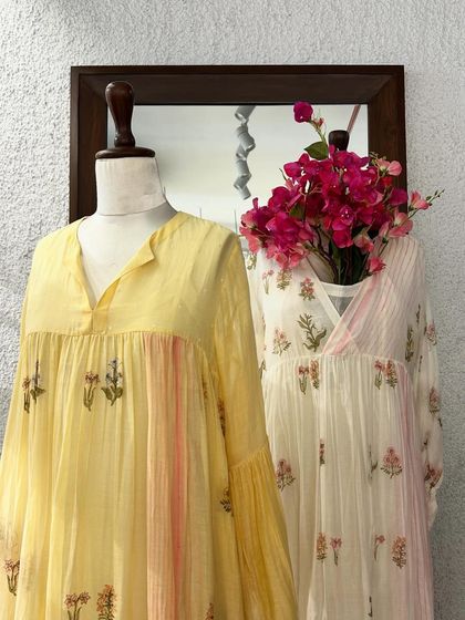 A closer look at the floral printed dresses, highlighting their delicate patterns and soft, breathable fabric.