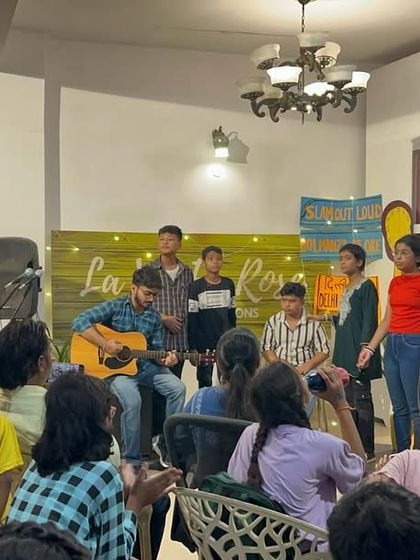 A wider shot of the Gully Choir's performance at the open mic. It highlights the intimate and supportive atmosphere where our young artists can connect with the audience.