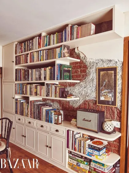 For Dia Mirza's home, we exposed a section of the original brick wall to create a feature for her extensive book collection. This blend of raw texture with refined, custom cabinetry is a hallmark of my design approach, creating a space that feels both smart and soulful.