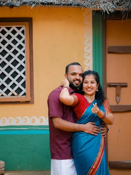 A playful and affectionate moment between the couple, captured at our village-themed set. Their traditional attire adds to the authentic feel of the photograph.
