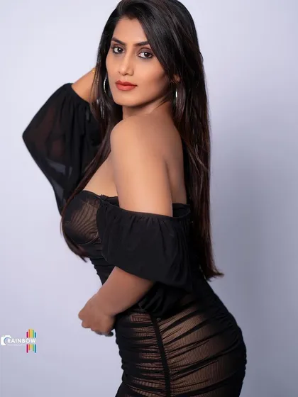 A modern and edgy studio portrait in a sheer black dress, showcasing a high-fashion aesthetic.