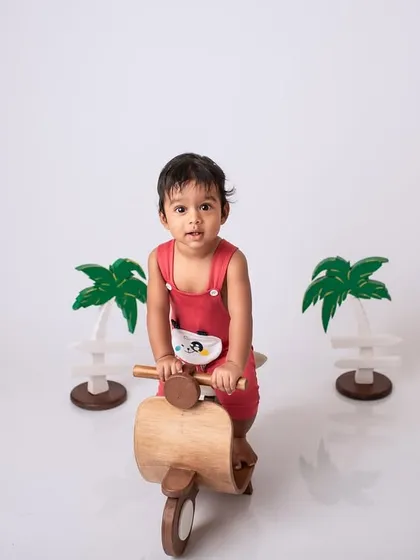 Let's go for a ride. This themed baby shoot uses a fun wooden scooter prop to create a playful and imaginative portrait.