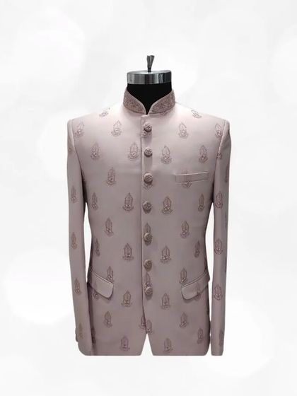 Simple yet elegant, this light pink Jodhpuri suit with subtle buti embroidery is a testament to timeless style. A great addition to any formal ethnic wardrobe.